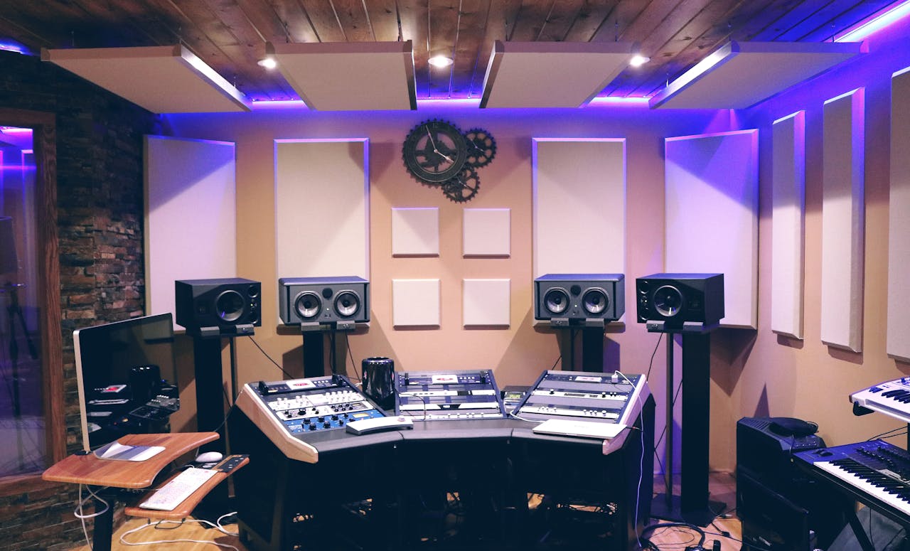 why-choose-us Modern recording studio with high-tech audio equipment and stylish lighting.