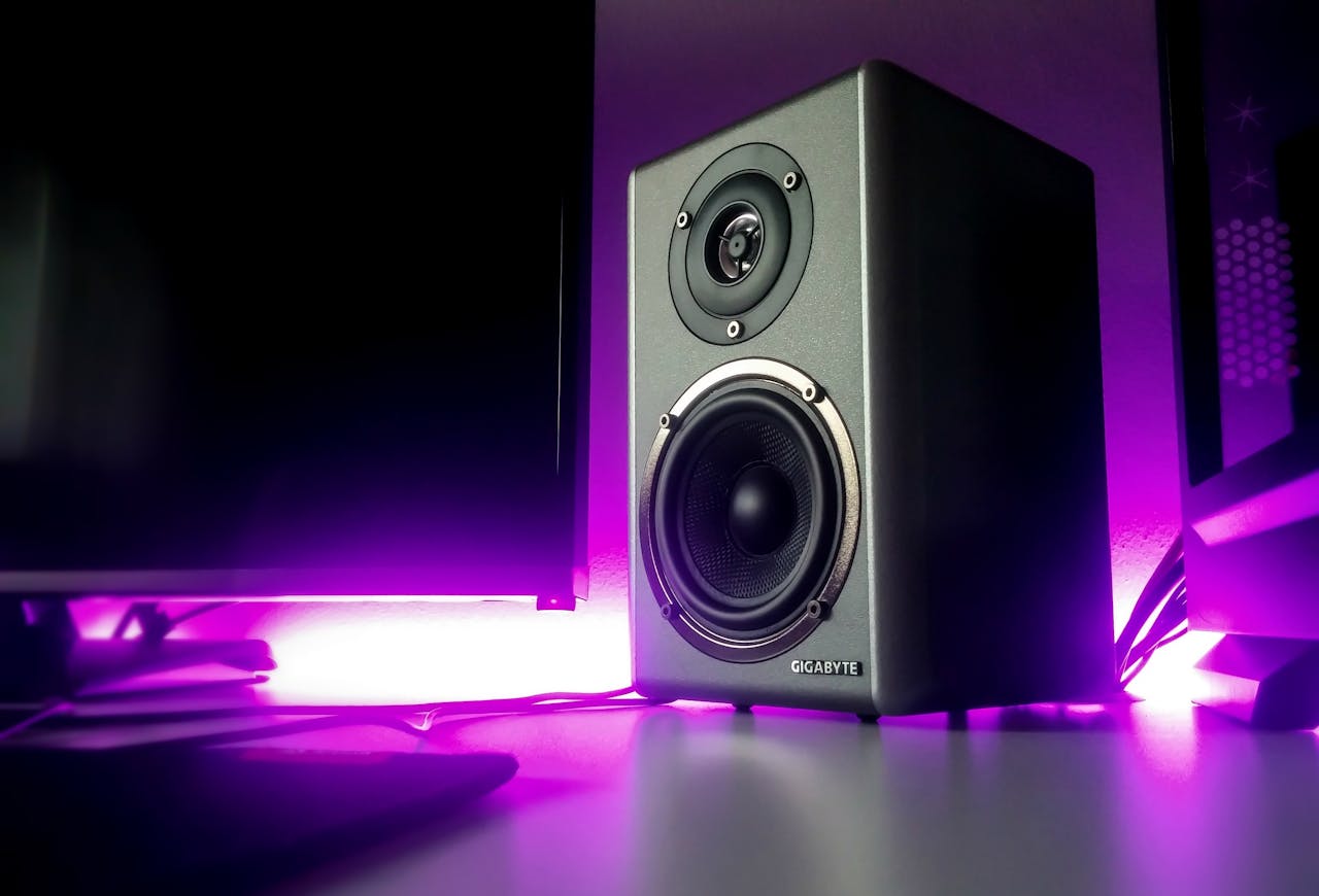 ours-journey High-quality speaker setup with vibrant purple lighting in a modern studio setting.