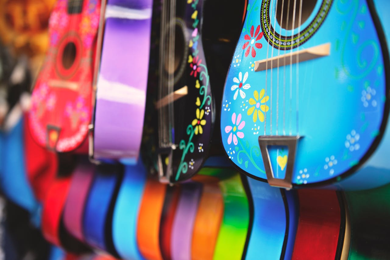 our-services-1 Vibrant close-up of artistically decorated acoustic guitars with floral patterns.